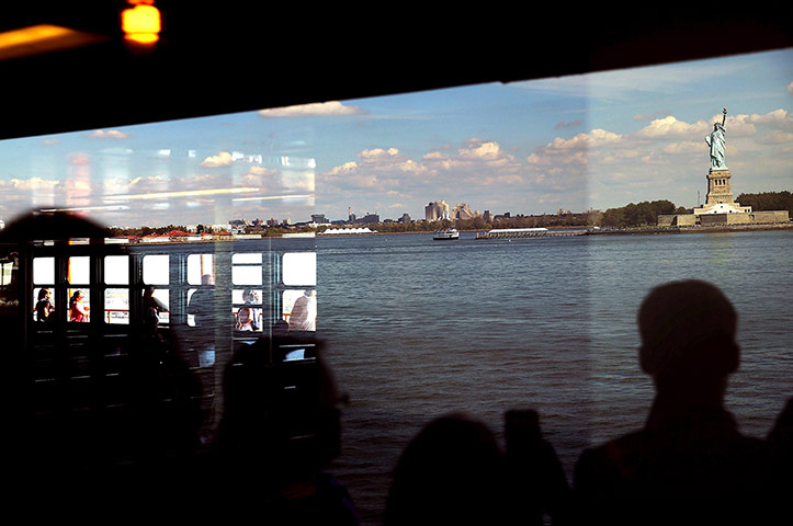 20 Photos: People on the Staten Island ferry look at the Statue of Liberty