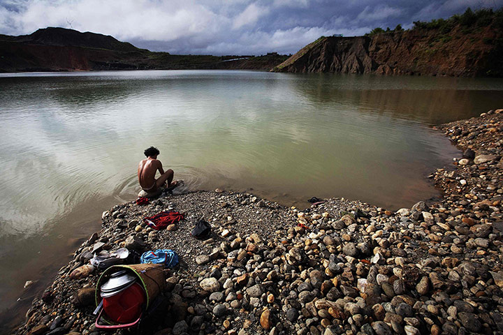 20 Photos: A hand-picker washes himself after searching for jade in Myanmar