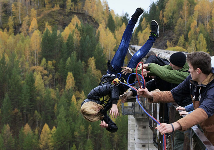 20 Photos: A woman rope jumps from a 44m high waterpipe in Krasnoyarsk, Russia