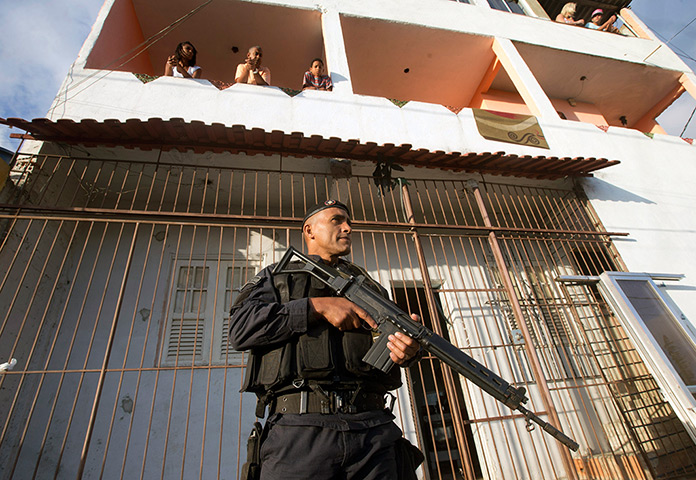 Favela clearance: A police officer patrols the Lins slum complex during an operation to insta