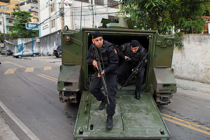 Favela clearances: Special Police Operations Battalion policemen get out of an armoured vehicl