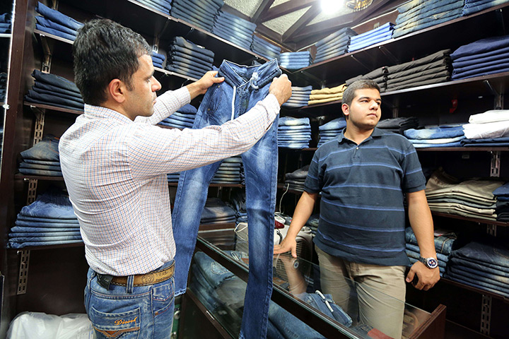 Iranian jeans: A man looks at a pair of jeans at shop in Tehran 