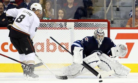 Anaheim Ducks forward Teemu Selanne tries to deflect a shot against Winnipeg Jets' Ondrej Pavelec