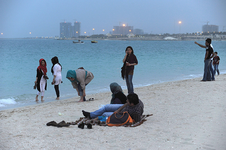 Iranian jeans: Women on the beach at dusk in Kish, a resort island in the Persian Gulf