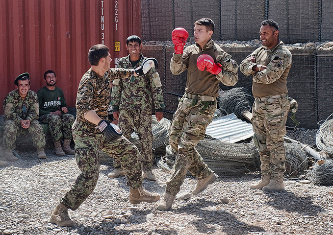Army Photographic winners: Soldiers from 1SCOTS bonding with their Afghan brothers at one of the check