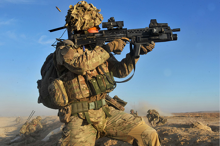 Army Photographic winners: Cpl Carl Hines Royal Artillery, provides covering fire while members of the