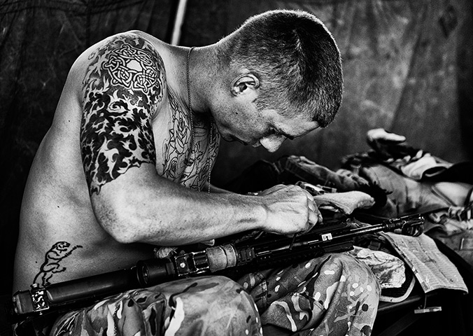 Army Photographic winners: Private Ross Cunningham from 1SCOTS cleaning his personal weapon at Forward