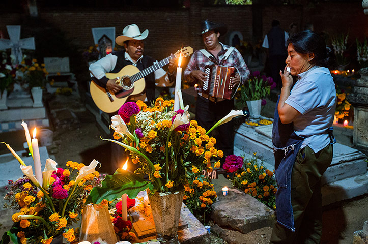 Day of the dead Mariachi band play at a tomb in Mexico