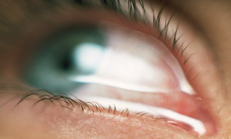 A tear-filled green eye