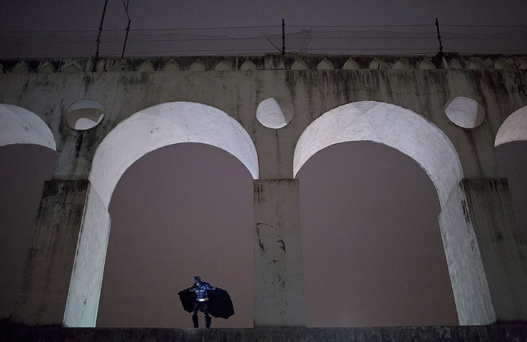 20 Photos: A protester wearing a Batman costume stands on the Carioca Aqueduct