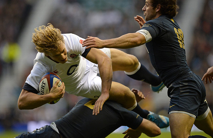 England v Argentina: Billy Twelvetrees flies over a tackle from Juan Manuel Leguizamon
