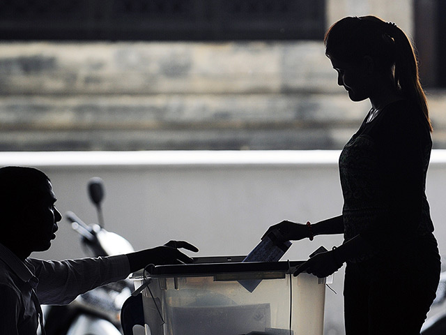 Weekend in pictures: Male, Maldives: A voter casts her ballot at a polling station in the third 