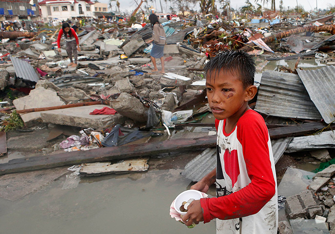 Weekend in pictures: Tacloban, Philippines: Residents gather coins and other salvageable materia
