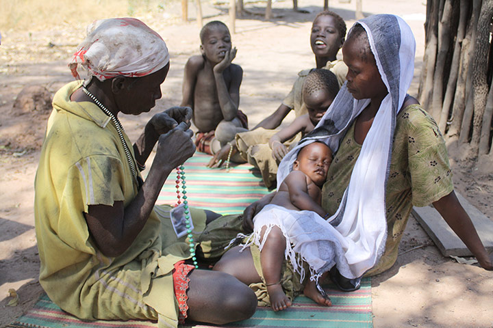Breath counters in use: Nyidumo uses counting beads to determine whether a child has pneumonia
