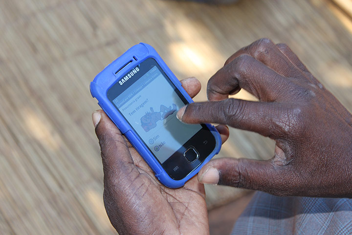 Breath counters in use: A community health worker in Mozambique uses the CommCare App