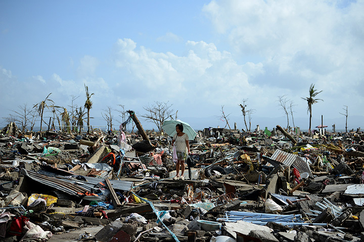 Tacloban survivors: A survivor walks among the debris of houses in Tacloban 