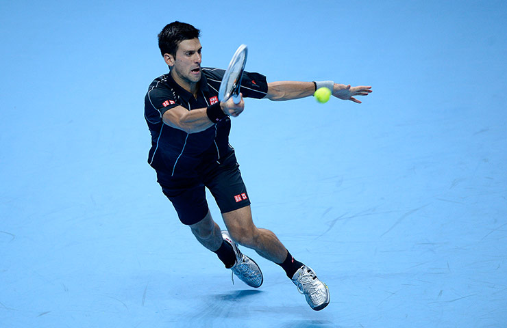 atp world final: Novak Djokovic stretches to make a shot