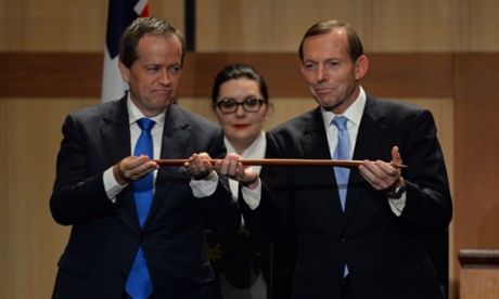 Whimsy before hostilities: Tony Abbott and Opposition Leader Bill Shorten hold a boomerang as they attend the Welcome to Country ceremony at Parliament. (AAP Image for The Guardian/Lukas Coch)