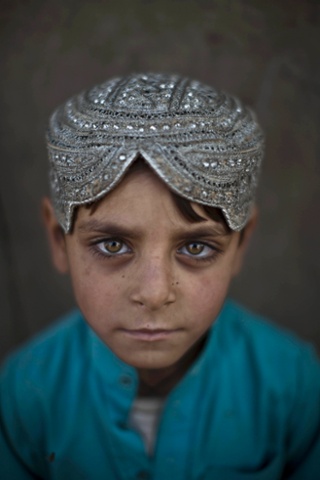 The work of photographer Muhammed Muheisan regularly appears in our top 10. Afghan refugee Hasanat Mohammed, 5, poses for a portraitoutside his home in a poor neighborhood on the outskirts of Islamabad, Pakistan.