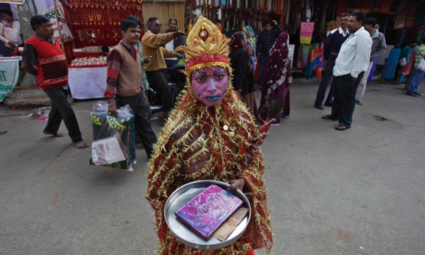 An elaborately decorated child is dressed as a Hindu deity to attract alms during the annual cattle fair in Pushkar in the western state of Rajasthan, India.