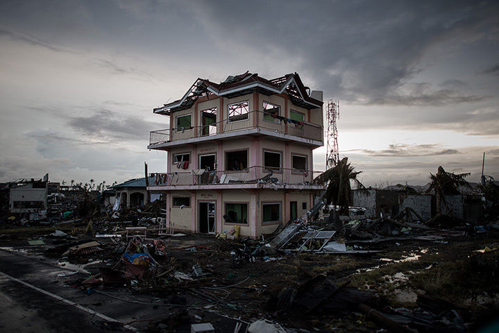 Typhoon Haiyan: The sun sets over a house damaged by Typhoon Haiyan outside the airport in 