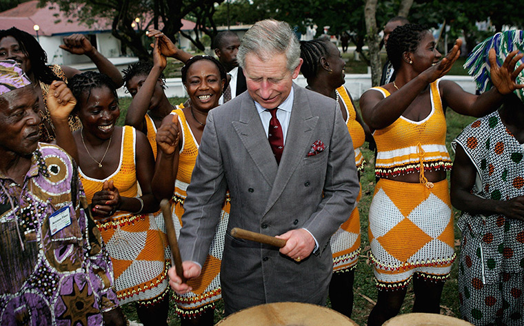 Charles's moments: Prince Charles plays drums with dancers of the Sierra Leone National Band T