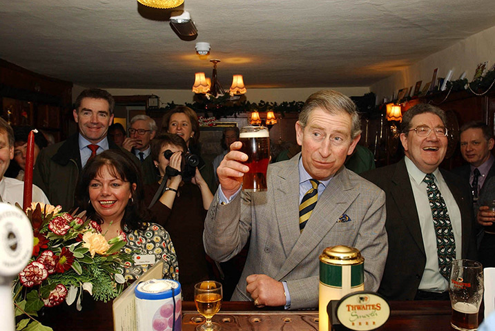 Charles's moments: Prince Charles raises a glass as he samples a pint of beer during a visit t