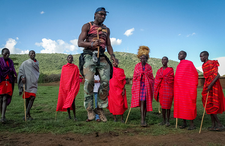 Your Pictures - Culture: man jumping surrounded by African tribe in red