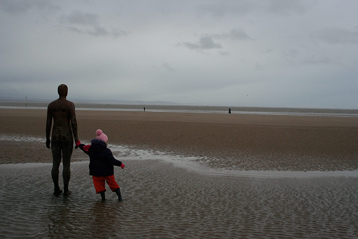 Your Pictures - Culture: Small child plays with Anthony Gormley sculpture on beach