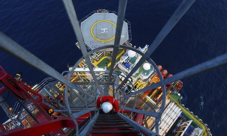 An engineer climbs down from a drilling tower