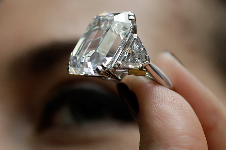 Diamonds: A employee holds a 34.05 carat rectangular-cut diamond ring during an aucti