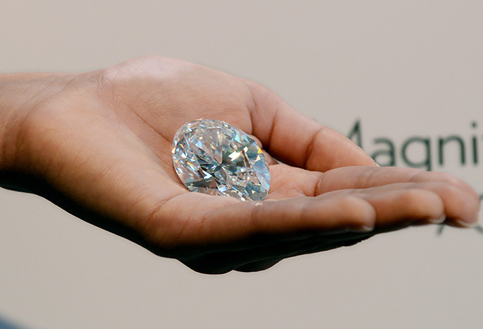 Diamonds: A Sotheby's employee holds a 118.28 carat, D Colour Flawless, type11A, Magn