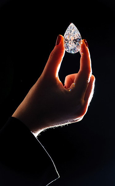 Diamonds: A Christie's employee holds a 101.73 carat pear-shaped diamond, the largest