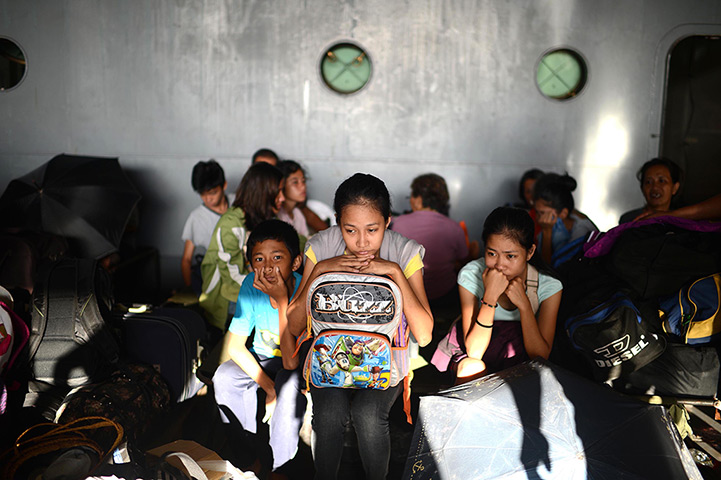 Philippines survivors: Children shelter in a school building with their families, in Tacloban