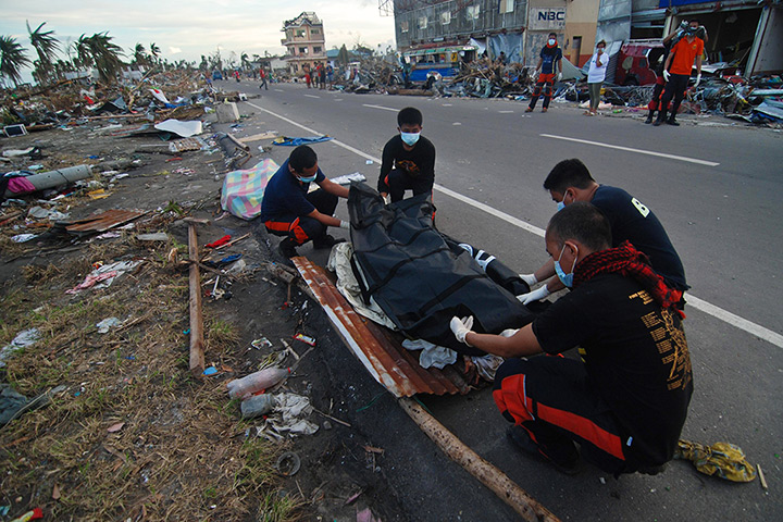 Philippines survivors: Members of the fire department retrieve bodies from the rubble in Tacloban 