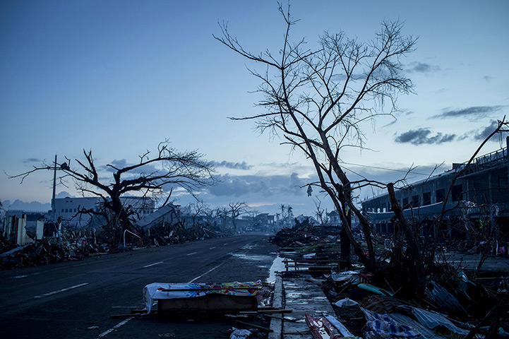 Philippines survivors: A homemade casket is seen on the side of the road as curfew approaches in L