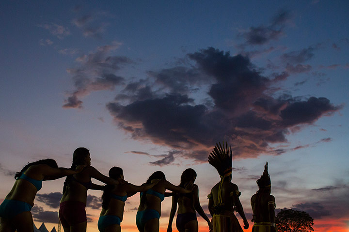 Indigenous Games: Men walk in line as they arrive for the tug of war competition