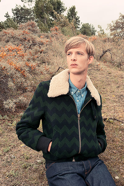 Outerwear: Model wearing woollen bomber jacket by Ami