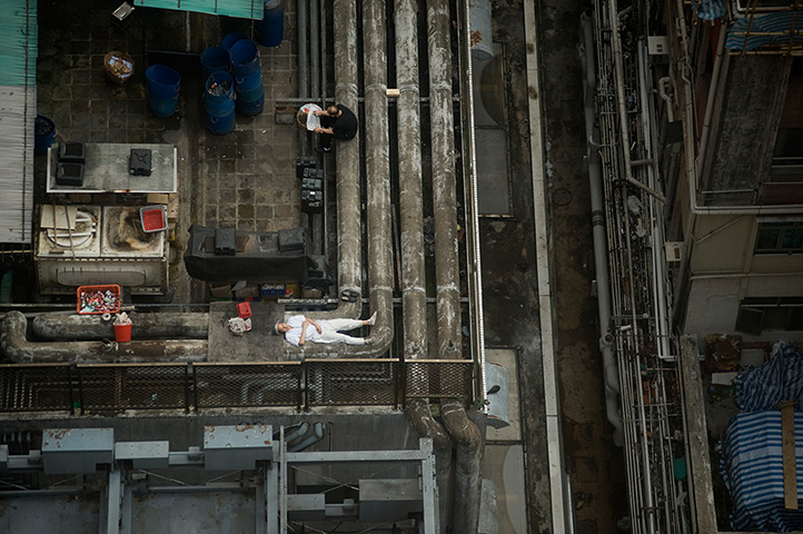eyewitness: cities: A worker sleeps on a restaurant rooftop in Hong Kong, China