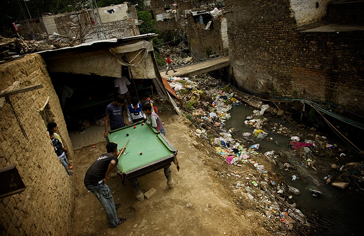 eyewitness: cities: Boys play billiards in a Christian neighbourhood of Islamabad, Pakistan