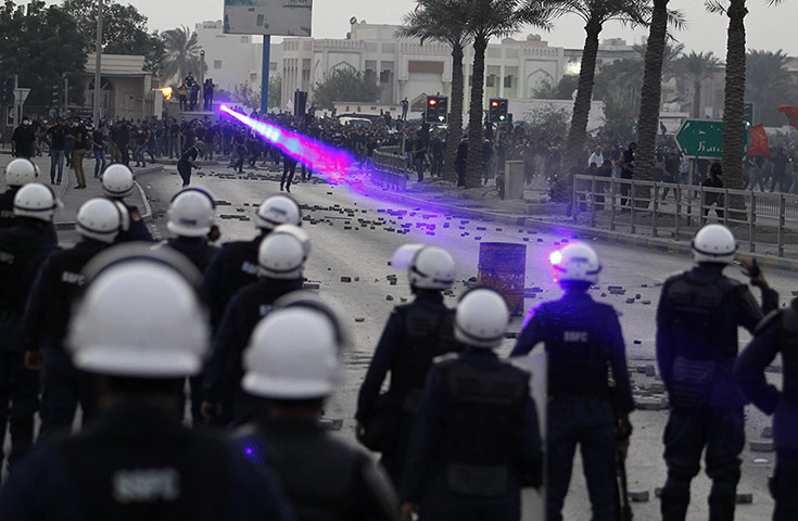 20 Photos: Anti-government protesters aim laser beams at riot police in Bahrain