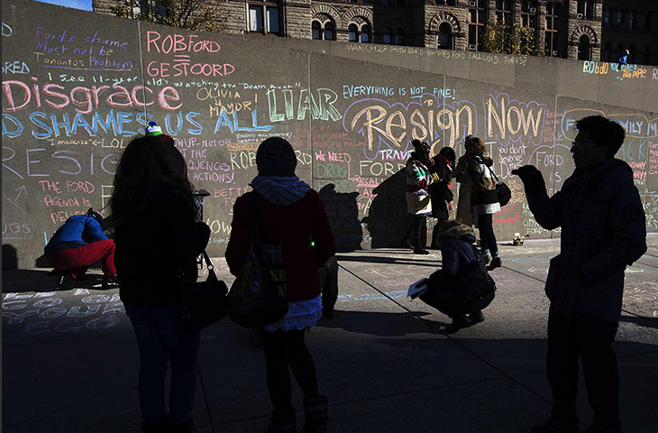 20 Photos: People are silhouetted against a wall in Toronto