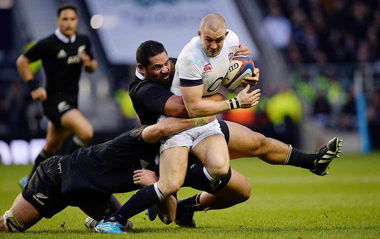 England v New Zealand: Mike Brown is stopped by Charlie Faumuina and Sam Whitelock