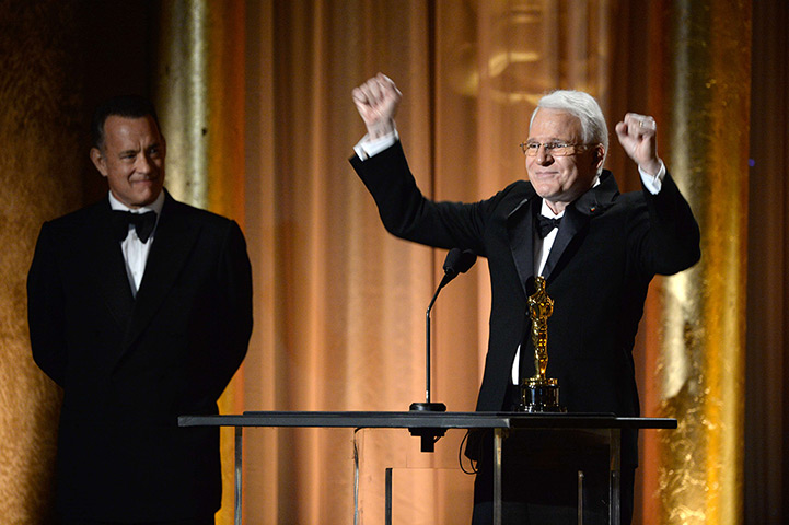 Governors Awards : Tom Hanks watches as actor Steve Martin accepts an honorary award 