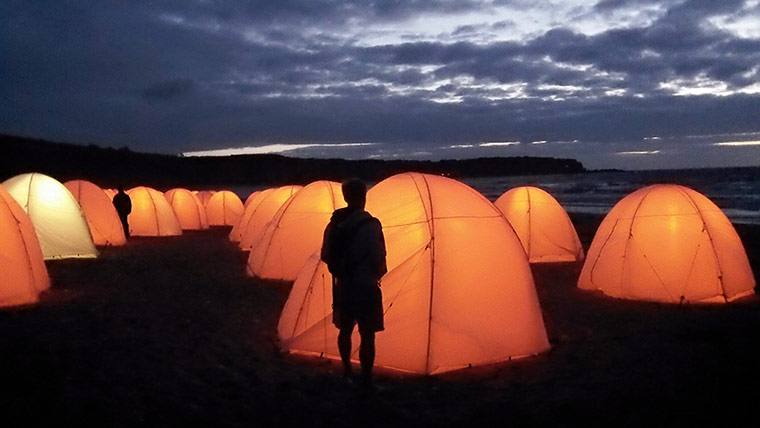 Your Pictures - Culture: man standing in front of illuminated tents