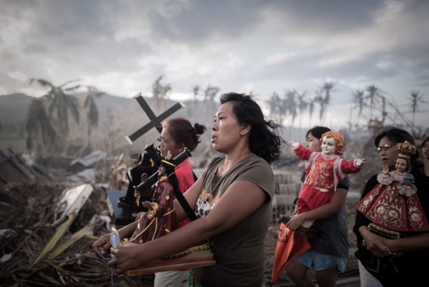 Survivors of Typhoon Haiyan make their way across the devastated landscape during a religious procession in Tolosa on the eastern Philippine island of Leyte.