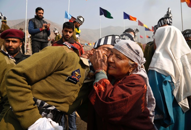 An Indian Jammu and Kashmir police force member is congratulated by his mother during a passing-out parade at Lethpora, south of Srinagar.
