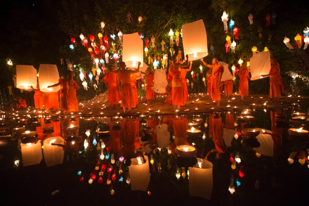A magical scene in Thailand as buddhist monks prepare to release lanterns after a blessing ceremony during the Loy Krathong Festival at a temple in Chiang Mai.