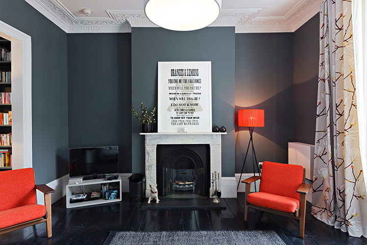 Homes - Lighten Up: interior of living room with grey walls and orange chairs