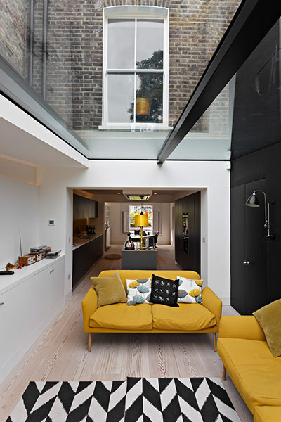 Homes - Lighten Up: conservatory with yellow sofas and black and white rug